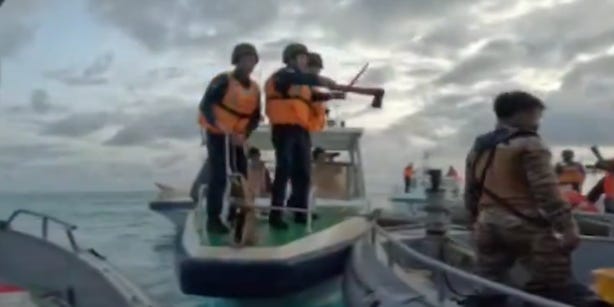 Video shows Chinese coast guard brandishing an ax in a low-tech clash with the Philippines navy