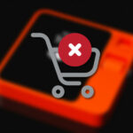 Red X over shopping cart on blurred rabbit r1 device in background