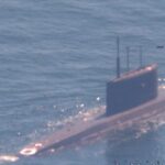 A NATO sub hunter captured these shots of a Russian submarine in waters newly surrounded by the alliance