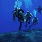 Check out these stunning underwater photos of reconnaissance Marines diving next to a US missile submarine in the open ocean