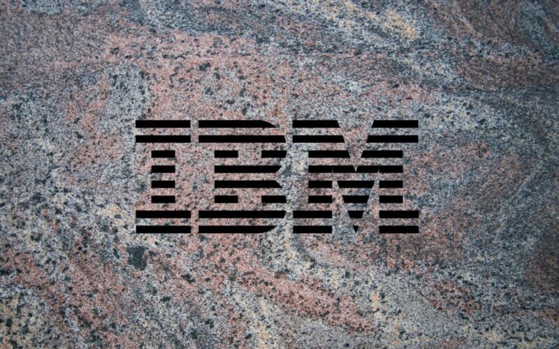 IBM logo on a granite background to illustrate the launch of the company's Granite 3.0 family of AI models alongside an open-source commitment.