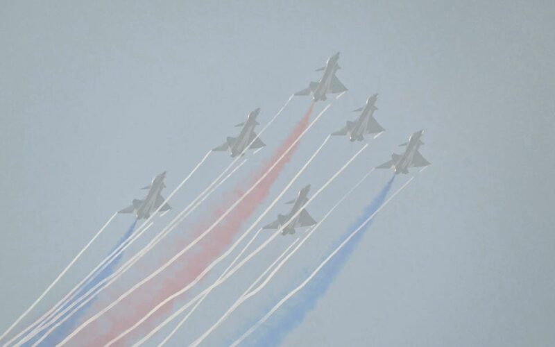 China's big air show opened with a glitzy aerial display of its fighters, but crowds couldn't see much in the smog