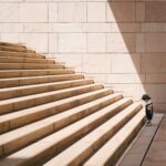 Kid facing the challenge of large stairs illustrating the diminishing returns that OpenAI is reportedly facing with the training and development of its latest AI model.