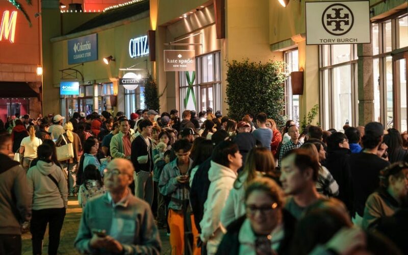 Photos show Black Friday crowds at retailers across the US even as more shoppers move online