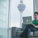 Man working on a computer illustrating a report from the Tony Blair Institute highlighting AI's potential impact on the workforce, including the opportunities and risks to the labor market and how government and policymakers can mitigate the challenges.